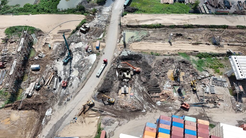 pexels photo 33311769 Aerial view of a busy construction site with heavy machinery and containers.