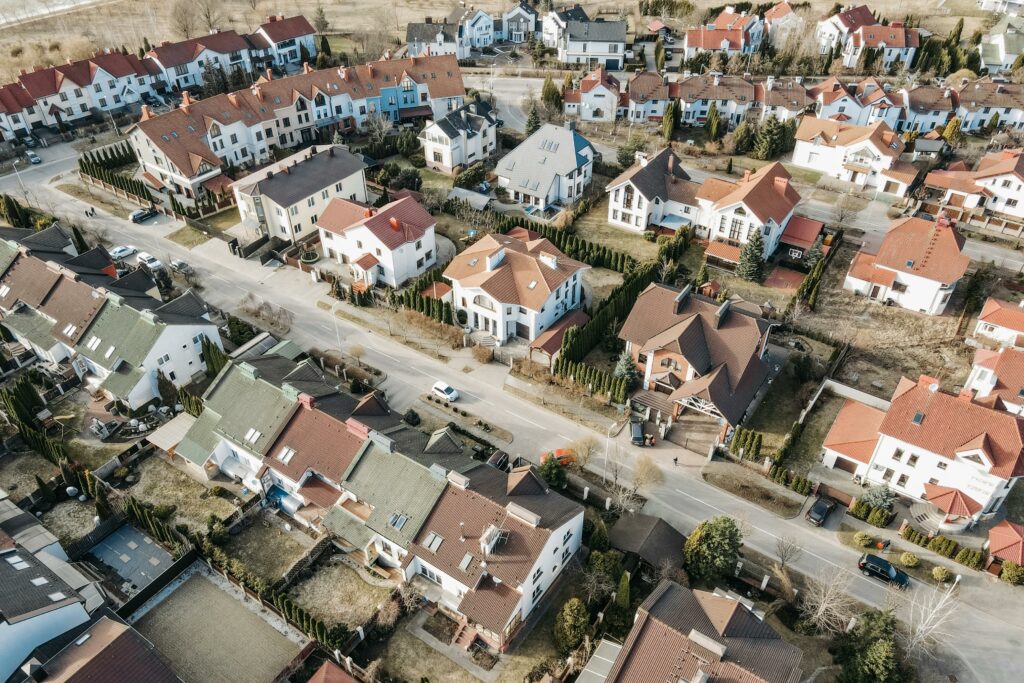 pexels photo 7937274 7937274 Drone view of a suburban residential area with houses and streets in daylight.
